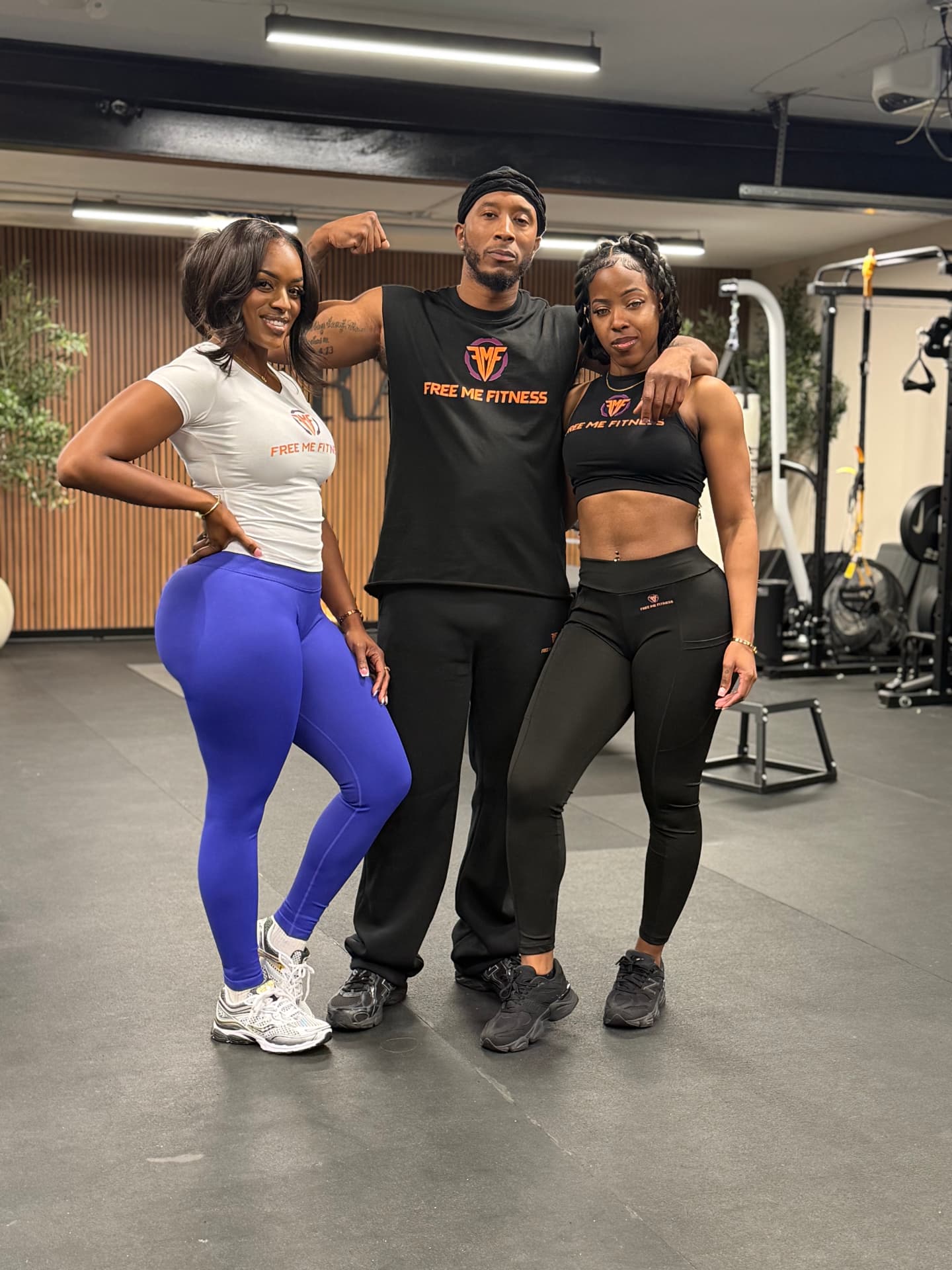 Free Me Fitness coach with two members in the gym